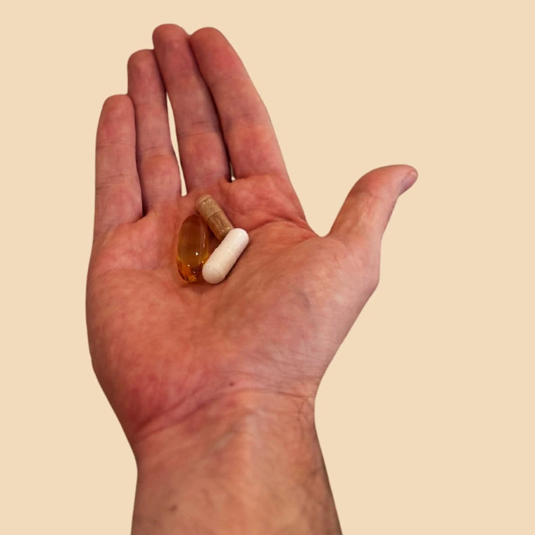 Three pills from one Goldmind:Focus daily sachet shown in an open hand.